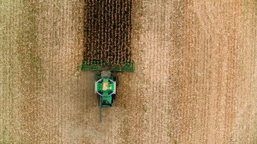 Top down view of green combine harvesting field