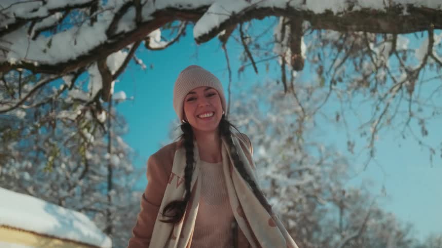 A woman throws a snowball