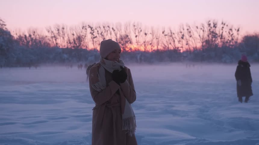 A clip of a lady enjoying the cold winter weather