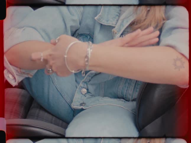 Closeup of a womans arms with silver bracelets and rings