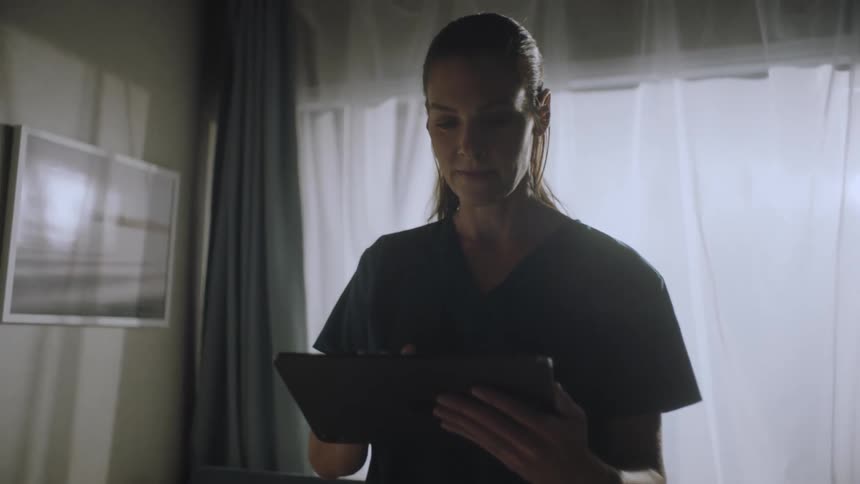 A medical professional is using a tablet