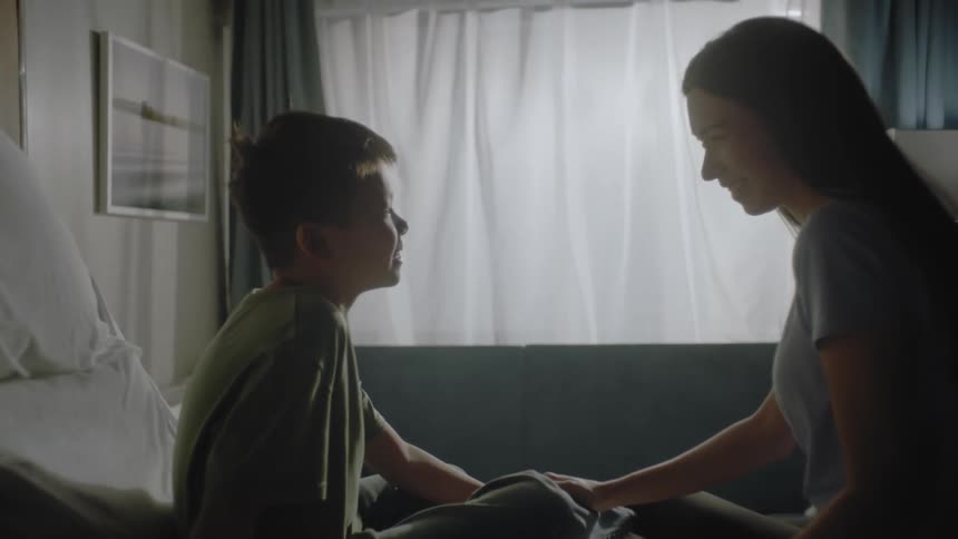 Mother and son talking in a room