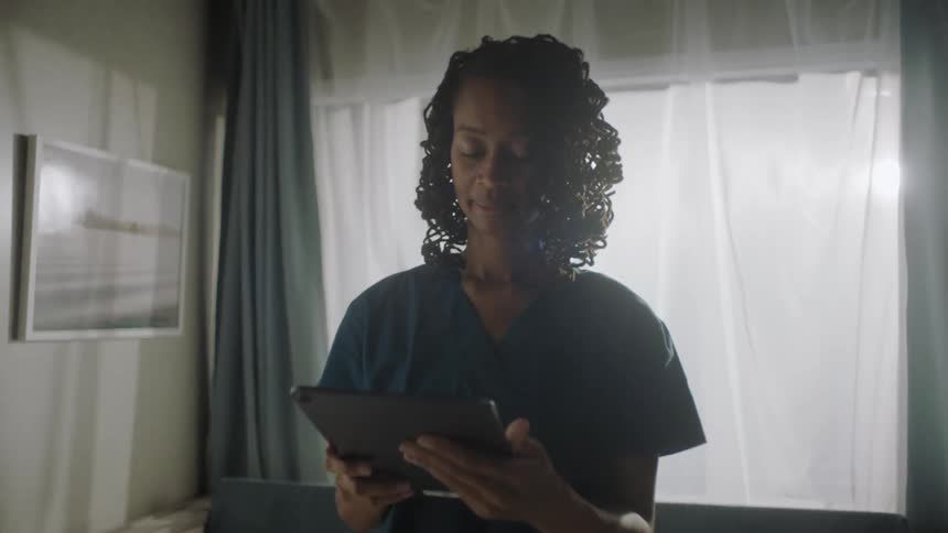 Portrait of a smiling female nurse with a tablet in her hands