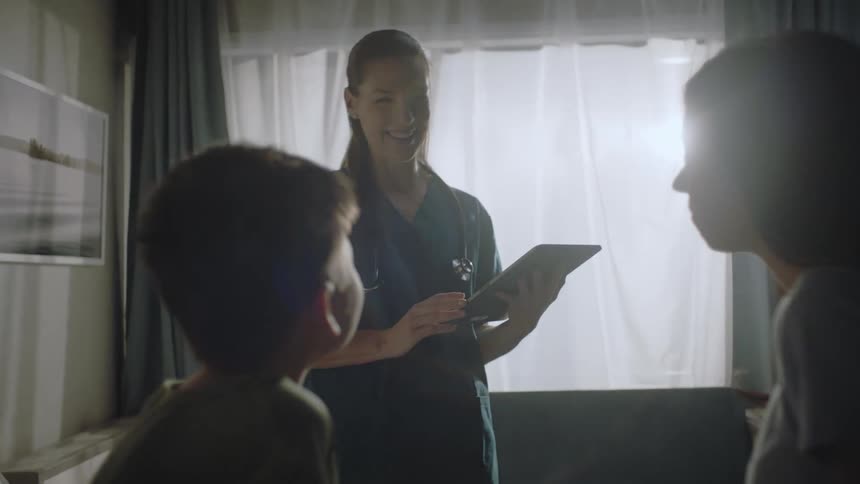 A doctor talking to her patient in a hospital room