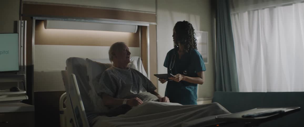 A doctor walks up to a patient