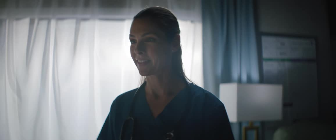 Nurse in a room having a conversation with another person