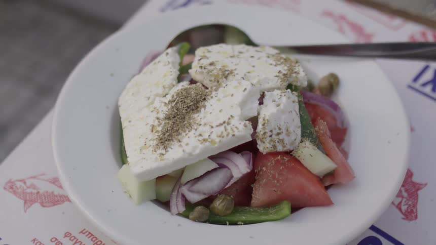A salad is served on the table