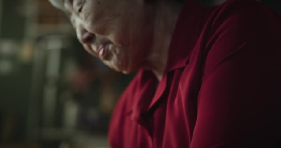 Grandmother tries to hold on to granddaughter and an orange while sitting