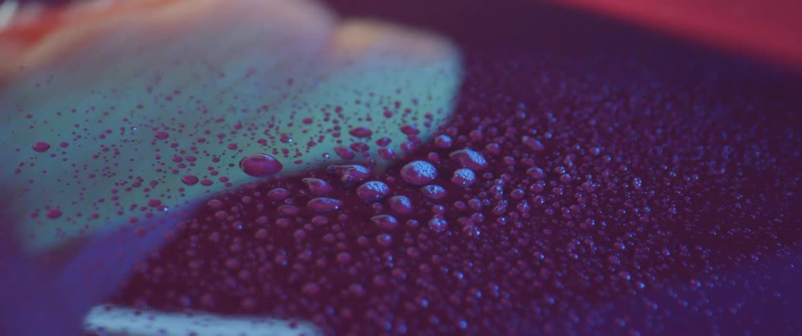 Liquid spraying unto a reflective surface and wiped off with a sponge