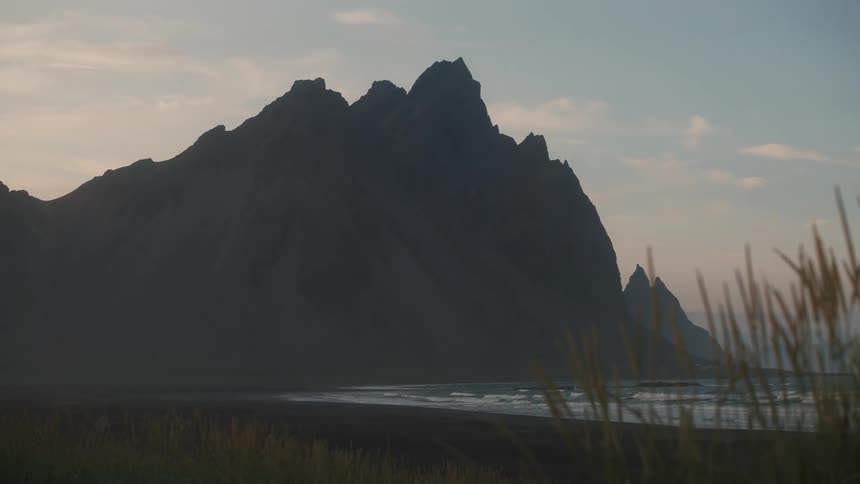 A mountain looming over a beach