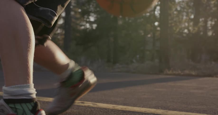 A person dribbles a basketball