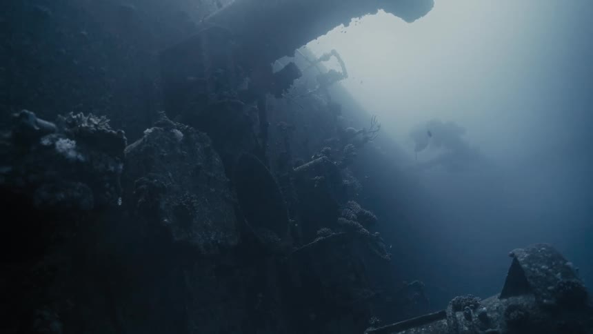 View from inside the sea with a sunken ship amidst the mud