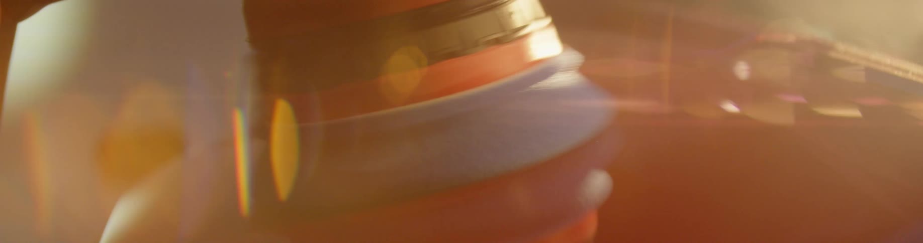 Extreme closeup of the reflection of a polishing machine on a car
