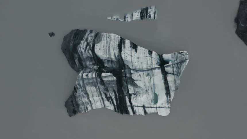 Abstract visual arts and rocky fragment amid a grayish soil
