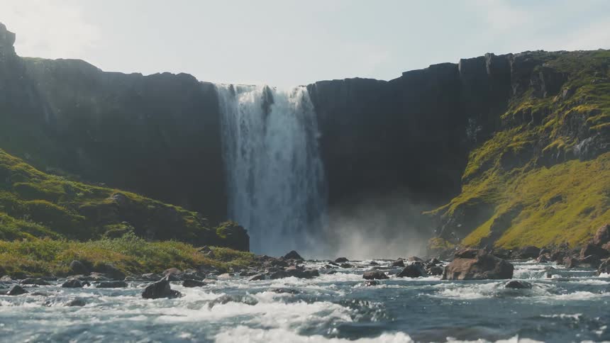 View of a powerful waterfall in the midst of a valley