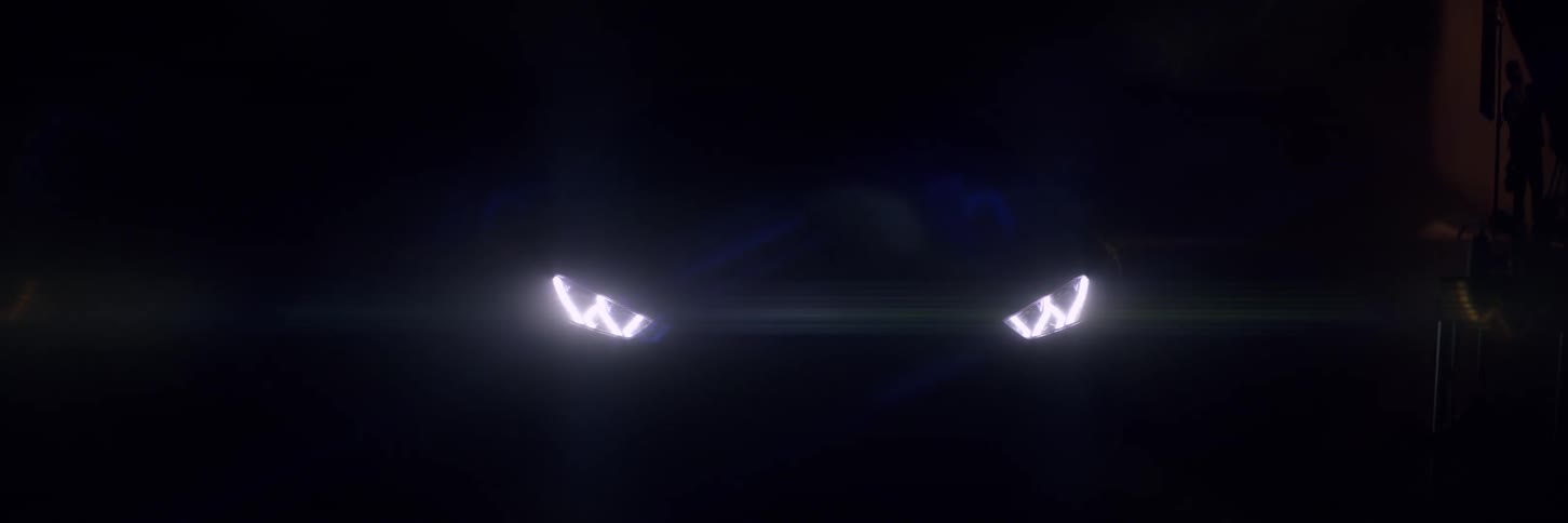 Headlights of a lamborghini turned on in a dark room