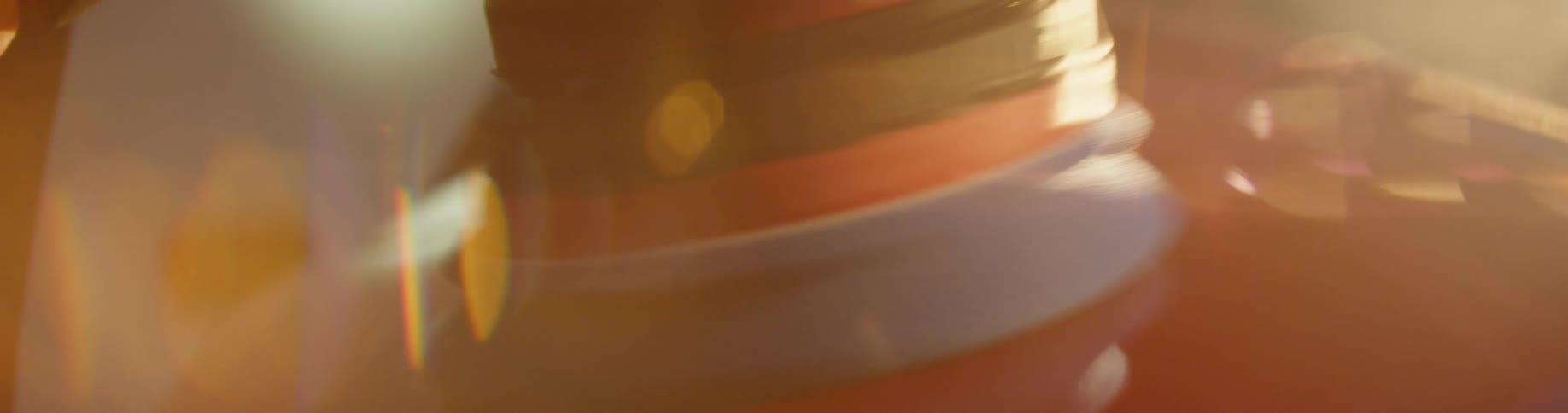 Reflection of a moving polishing machine on red bodywork