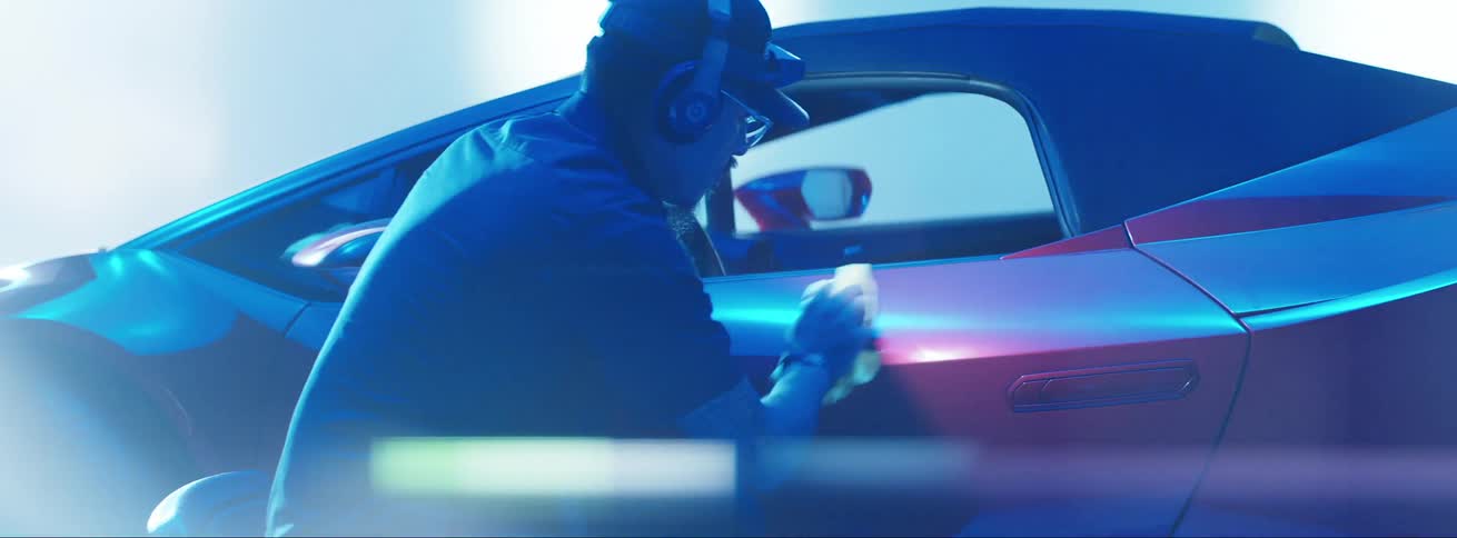 Man wiping the side of a red lamborghini with a cloth