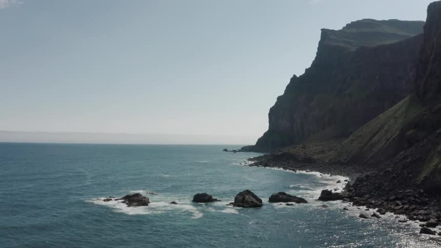 An ocean coast with a mountain of rocks