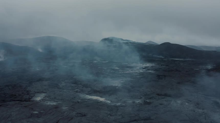 A volcanic mountain covered in smoke and mist