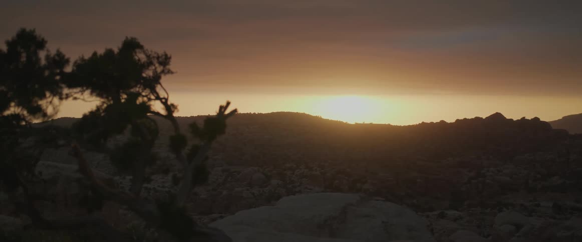A view of the horizon with the sun rising and it is very bright
