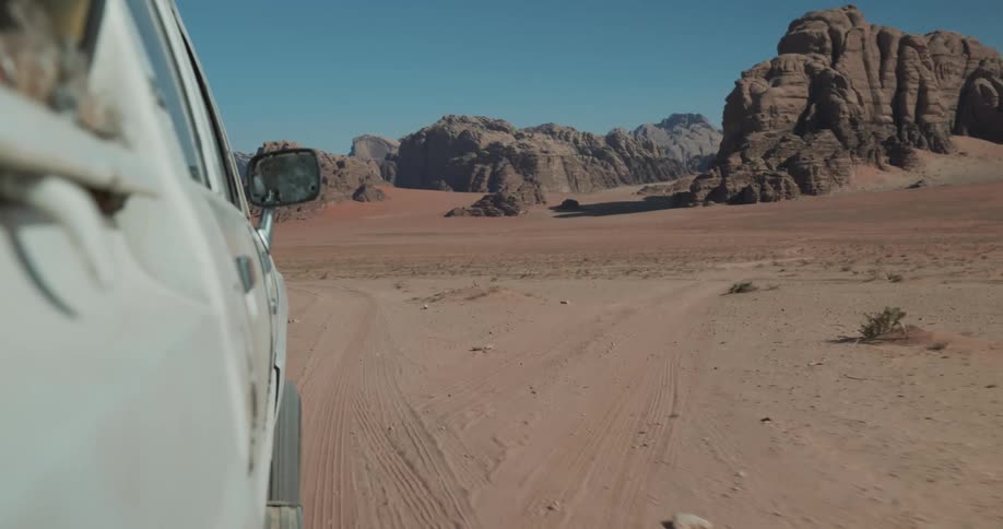 Vehicles passing through a valley surrounded by mountains