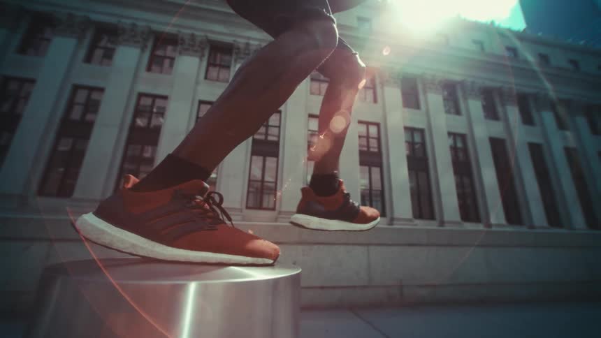 A person jumping over metal blocks in a city building