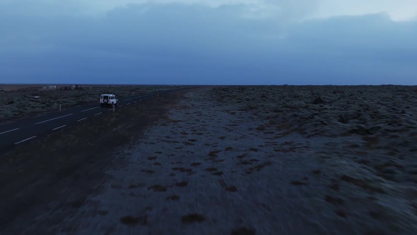 A car is driving down the highway