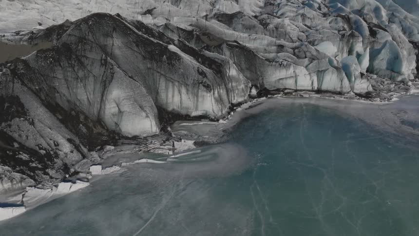The ocean is frozen by the shore