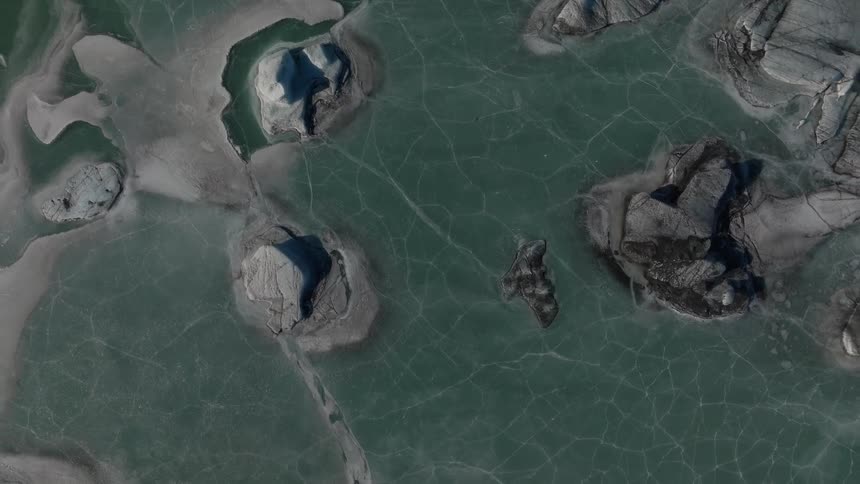 The water is frozen around the rocks
