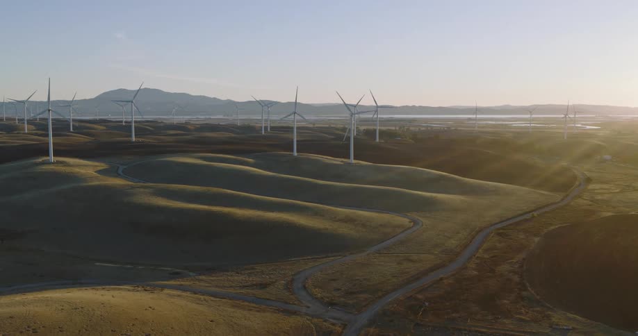 Aerial of a plain with wind farm during a sunny morning