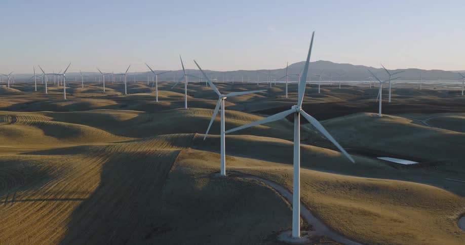 Panorama of wind turbine platforms and engines in motion in the morning