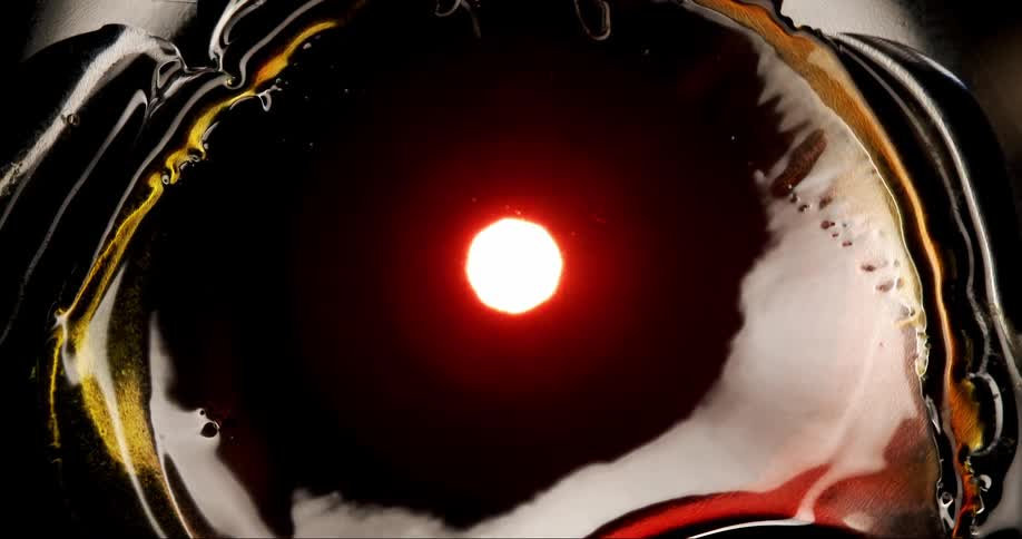 Abstract dense and liquid expanding fluid with a red focus in slow motion