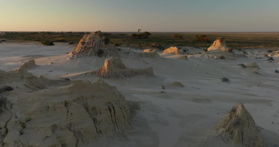View of small peaks in the desert next to a grasland on a morning