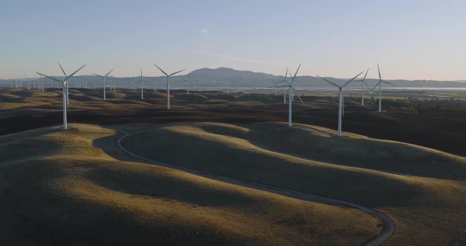 Aerial panorama of a field with wind energy turbines on a morning