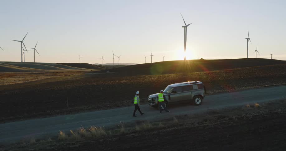 Two employees look over the wind farm