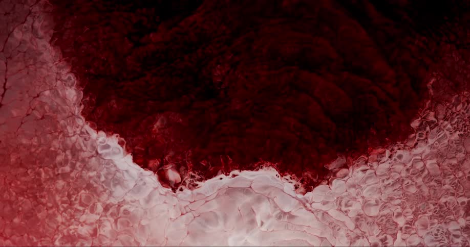 A rose color spread as it create bubbles on its path
