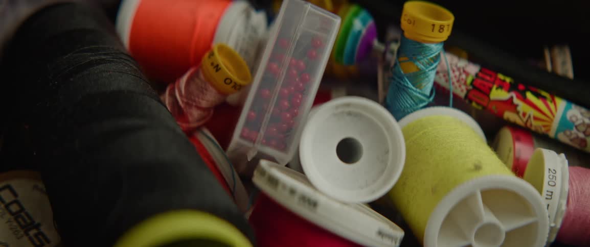 Closeup of a bag with various spools of thread