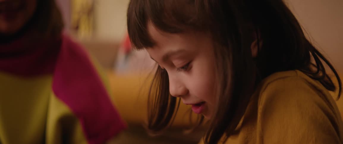 A girl cutting fabrics with scissors