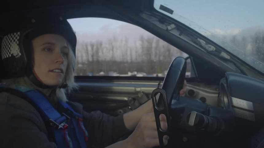 A woman drives a car in a rally