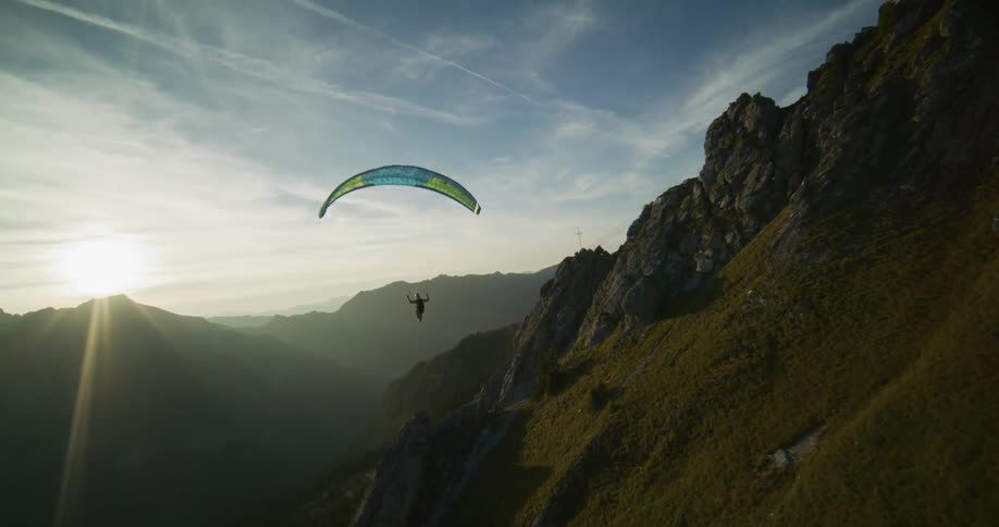 Aerial view of a paraglider floating over the mountains