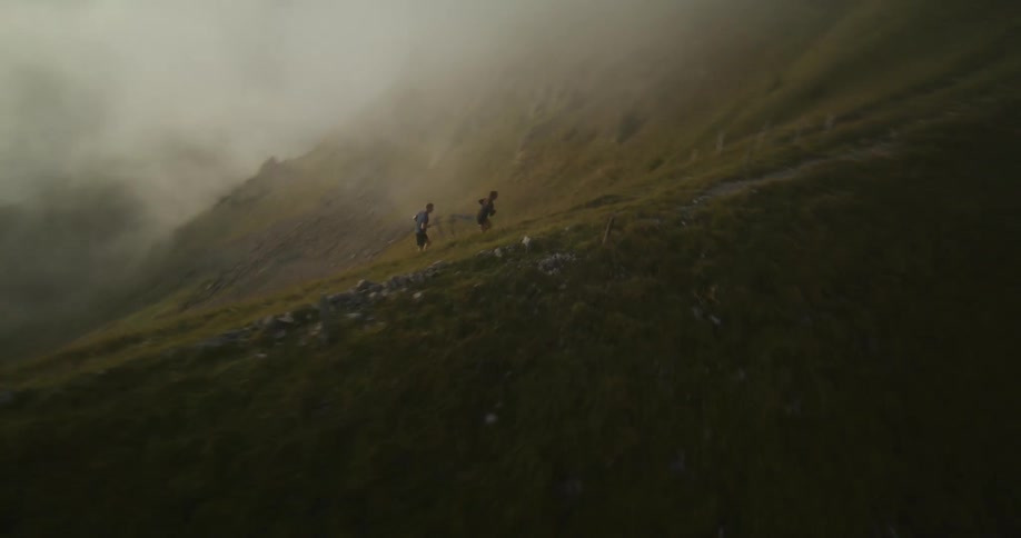 Two people run up the mountain together