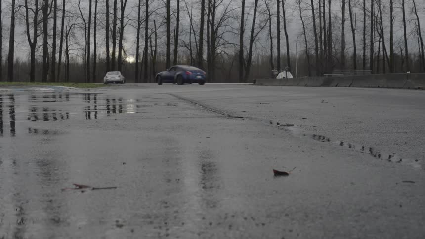 Two cars drifting on wet asphalt