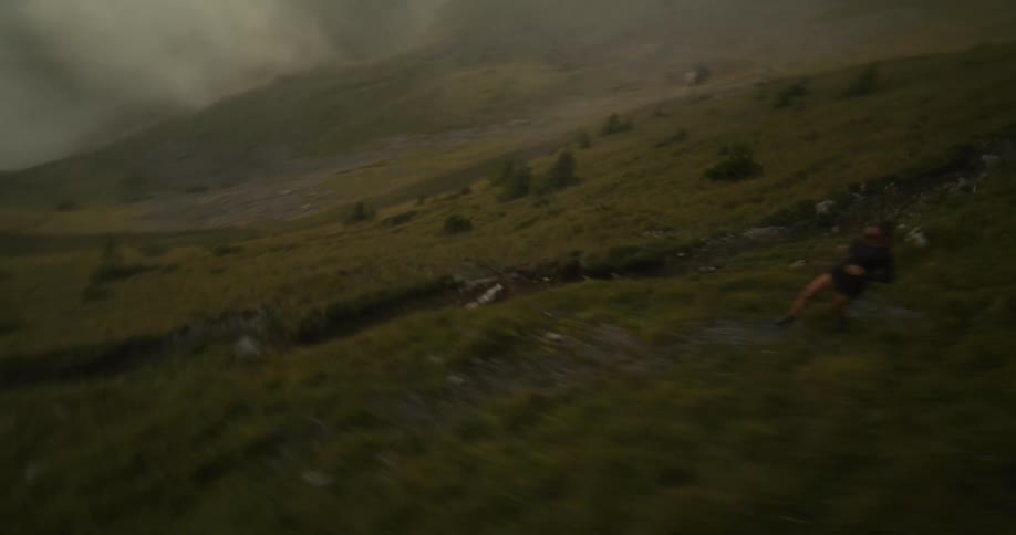 Two people run down the steep mountain