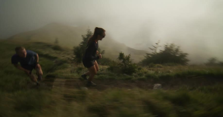 A man and woman run down the mountain