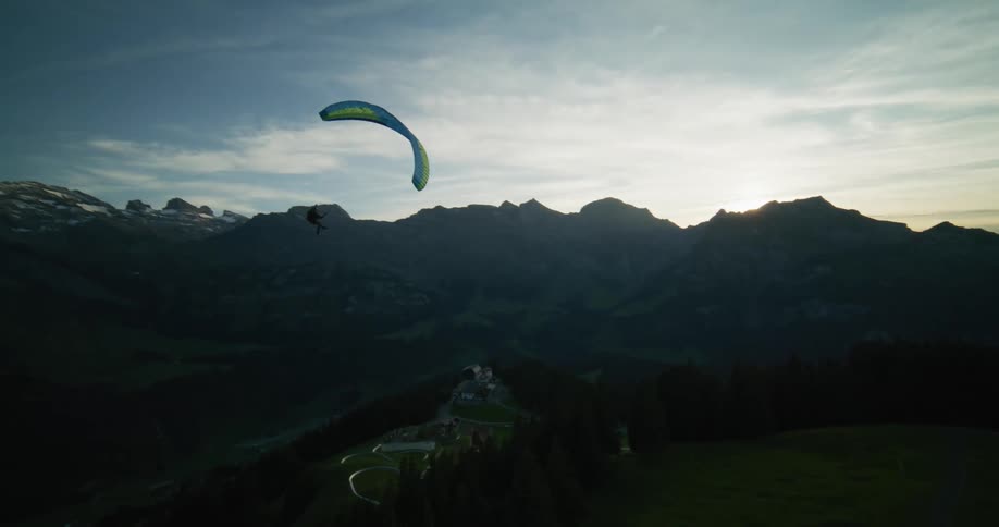 A person paragliding down the mountain