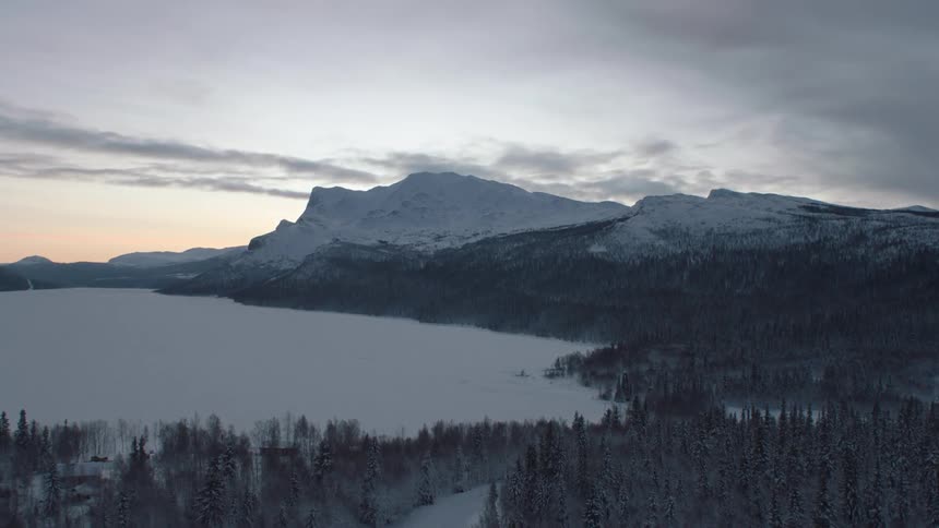Snow covered lake and mountains