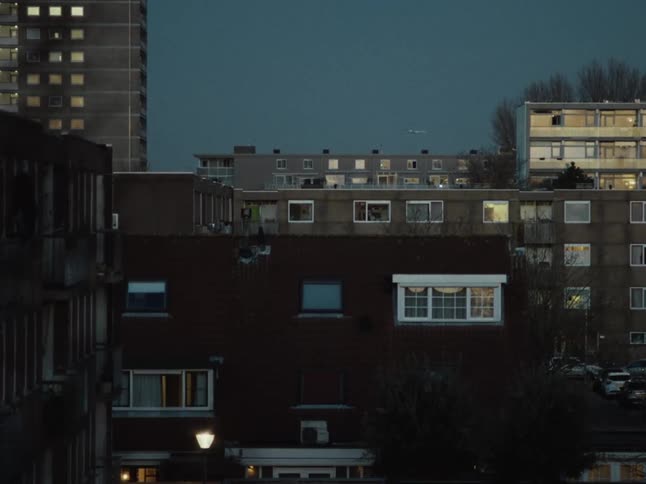 Airplane flying over the city at evening