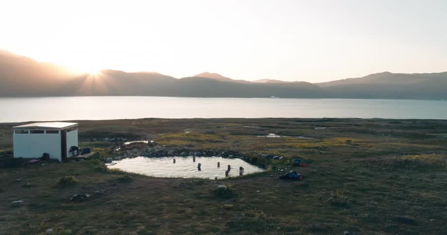 Group of people bath in a natural hot spring in Greenland