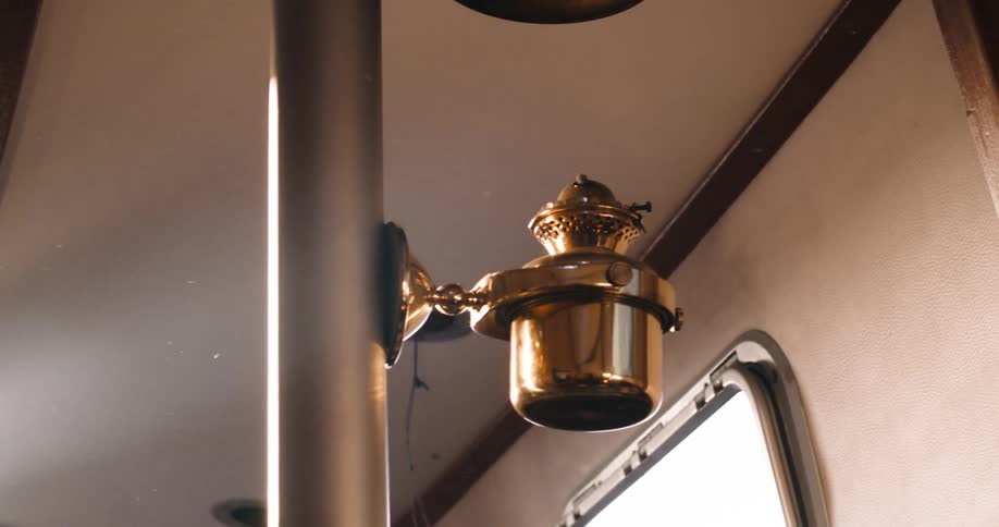 A bronze device hangs from the pole